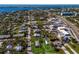 Aerial view showing a small house on a lot with surrounding houses and water at 4420 119Th W St, Cortez, FL 34215