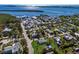 Aerial view showing a small house on a lot with surrounding houses and water at 4420 119Th W St, Cortez, FL 34215
