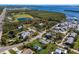 Aerial view showing a small house on a lot with surrounding houses and water at 4420 119Th W St, Cortez, FL 34215