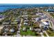 Aerial view showing a small house on a lot with surrounding houses and water at 4420 119Th W St, Cortez, FL 34215