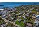 Aerial view showing a small house on a lot with surrounding houses and water at 4420 119Th W St, Cortez, FL 34215