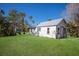 Small cottage with a metal roof and a large grassy backyard at 4420 119Th W St, Cortez, FL 34215