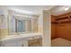 Bathroom with vanity, mirror, and built-in closet at 4540 Gulf Of Mexico Dr # 304, Longboat Key, FL 34228