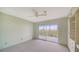 Spacious bedroom with carpeting, ceiling fan and sliding doors to balcony at 4540 Gulf Of Mexico Dr # 304, Longboat Key, FL 34228