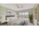 Bedroom with built-in shelving, ceiling fan, and access to a balcony at 4540 Gulf Of Mexico Dr # 304, Longboat Key, FL 34228