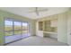 Bedroom includes a ceiling fan, sliding door to balcony, and built-in shelving at 4540 Gulf Of Mexico Dr # 304, Longboat Key, FL 34228