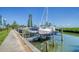 Boats on lifts at a waterfront community dock at 4540 Gulf Of Mexico Dr # 304, Longboat Key, FL 34228