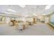 Spacious community room with tables, chairs, and a kitchenette at 4540 Gulf Of Mexico Dr # 304, Longboat Key, FL 34228
