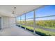 Bright enclosed balcony offers a relaxing space with ceiling fan and nature views at 4540 Gulf Of Mexico Dr # 304, Longboat Key, FL 34228