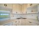 Bright kitchen features white cabinets, double sink, and built-in microwave at 4540 Gulf Of Mexico Dr # 304, Longboat Key, FL 34228