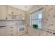 White kitchen cabinets, electric range, and microwave. View of a dining area at 4540 Gulf Of Mexico Dr # 304, Longboat Key, FL 34228