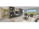 Bright living room with built-in shelving and large windows at 4540 Gulf Of Mexico Dr # 304, Longboat Key, FL 34228