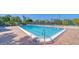 Community pool with surrounding brick patio and lounge chairs at 4540 Gulf Of Mexico Dr # 304, Longboat Key, FL 34228