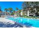Community pool with lounge chairs and adjacent building at 4540 Gulf Of Mexico Dr # 304, Longboat Key, FL 34228
