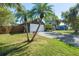 Home's exterior with a two-car garage and palm trees at 4905 22Nd E Ct, Bradenton, FL 34203