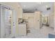 Kitchen with white cabinets, stainless steel appliances, and access to backyard at 4905 22Nd E Ct, Bradenton, FL 34203