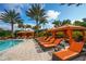 Unwind in a luxurious cabana by the pool with comfortable lounge chairs at 4937 Savona Run, Bradenton, FL 34211