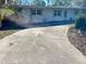 White single story home with driveway and mature landscaping at 5443 Avenida Del Mare, Sarasota, FL 34242