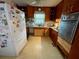 Galley kitchen with wood cabinets and white appliances at 5443 Avenida Del Mare, Sarasota, FL 34242