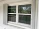 Double hung window with white frame and shutters at 5443 Avenida Del Mare, Sarasota, FL 34242