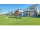 Large backyard featuring a playset, swing set, well maintained lawn and screened in patio for entertaining at 5548 Summit Gln, Bradenton, FL 34203