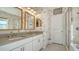 Modern bathroom featuring a double sink vanity, and large mirrors, and walk in shower at 5548 Summit Gln, Bradenton, FL 34203