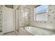 Bright bathroom with a large soaking tub, separate shower, and a window providing natural light at 5548 Summit Gln, Bradenton, FL 34203