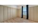 Empty bedroom featuring an accent wall, window, and wood flooring at 5548 Summit Gln, Bradenton, FL 34203