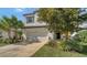Inviting home exterior with a lush front yard and a spacious driveway leading to a two-car garage at 5548 Summit Gln, Bradenton, FL 34203