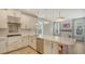 Bright and airy kitchen with an island, modern pendant lighting, stainless appliances, and ample cabinet space at 5548 Summit Gln, Bradenton, FL 34203