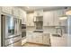 Modern kitchen featuring stainless steel appliances, stylish cabinetry, and quartz countertops at 5548 Summit Gln, Bradenton, FL 34203