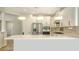 Open-concept kitchen featuring a large island, stainless steel appliances, pendant lighting, and ample counter space at 5548 Summit Gln, Bradenton, FL 34203