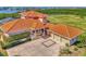 Luxury home with tile roof, three-car garage, and waterfront views at 5800 Tidewood Ave, Sarasota, FL 34231