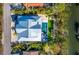 Aerial view of a modern home with a pool and lush landscaping at 598 Lyons Ln, Longboat Key, FL 34228