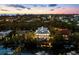 Waterfront property situated amongst other homes at dusk at 598 Lyons Ln, Longboat Key, FL 34228