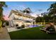 Inviting backyard oasis featuring a pool, patio furniture, and lush landscaping at 598 Lyons Ln, Longboat Key, FL 34228