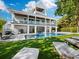 Luxury home with pool, expansive lawn, and outdoor seating at 598 Lyons Ln, Longboat Key, FL 34228