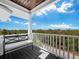 Relaxing balcony with a bench and a view of the lush surroundings at 598 Lyons Ln, Longboat Key, FL 34228