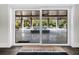 Sliding glass door view of the pool and patio from the finished basement at 598 Lyons Ln, Longboat Key, FL 34228