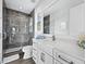 Modern bathroom with a walk-in shower and white vanity at 598 Lyons Ln, Longboat Key, FL 34228