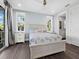 Cozy bedroom featuring a light-colored wooden bed and side table at 598 Lyons Ln, Longboat Key, FL 34228