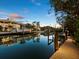 Evening view of private dock and calm canal waters at 598 Lyons Ln, Longboat Key, FL 34228