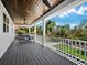 Covered deck with comfortable seating and wooden ceiling at 598 Lyons Ln, Longboat Key, FL 34228