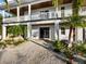 Front entrance of the home, showcasing a covered porch and attractive landscaping at 598 Lyons Ln, Longboat Key, FL 34228