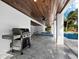 Stainless steel grill on patio near pool and spa at 598 Lyons Ln, Longboat Key, FL 34228