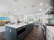 Open concept kitchen boasts a large island, stainless steel appliances, and white cabinetry at 598 Lyons Ln, Longboat Key, FL 34228