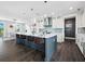 Modern kitchen with a large island, white cabinets, and a blue-gray island at 598 Lyons Ln, Longboat Key, FL 34228