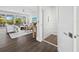 Open concept living room with home elevator, hardwood floors, and access to balcony at 598 Lyons Ln, Longboat Key, FL 34228