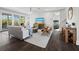 Spacious living room with comfortable seating, large TV, and hardwood floors at 598 Lyons Ln, Longboat Key, FL 34228