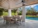 Outdoor patio with wooden dining table and chairs at 598 Lyons Ln, Longboat Key, FL 34228